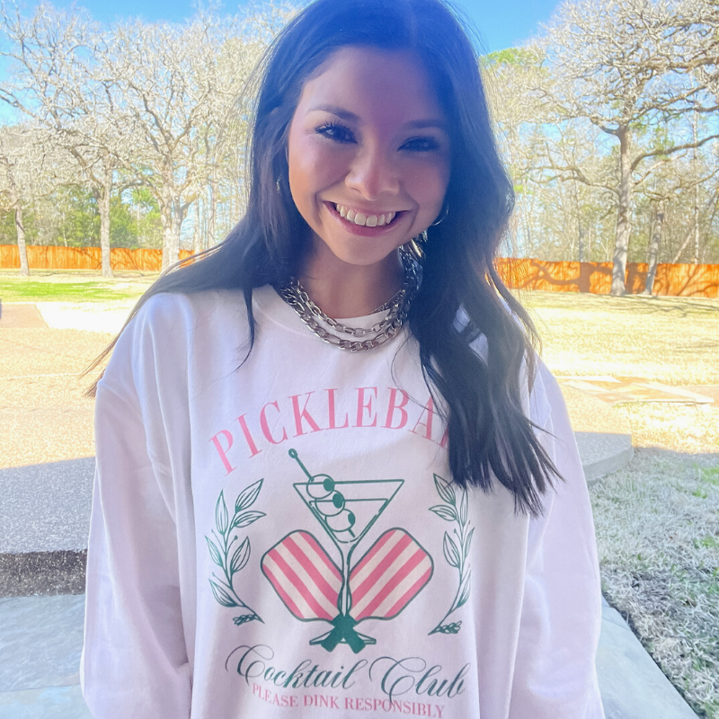 Online Exclusive | Pickleball Cocktail Club Coquette Long Sleeve Graphic Sweatshirt in White - Giddy Up Glamour Boutique