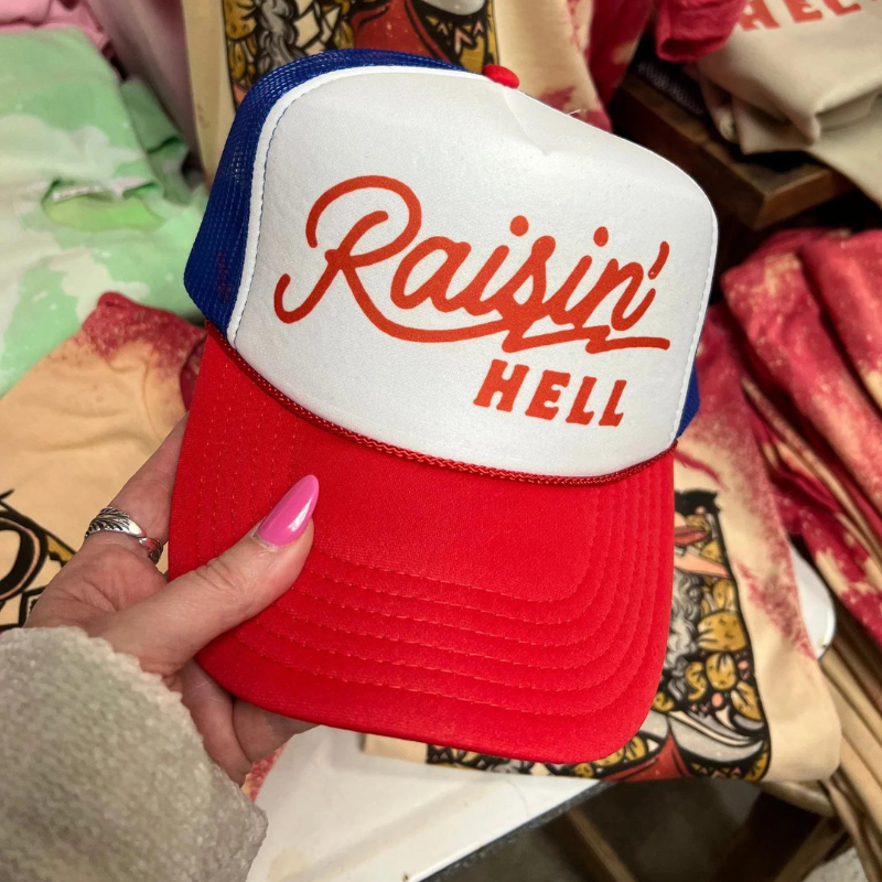 Online Exclusive | Raisin' Hell Foam Trucker Cap in Red, White, and Blue - Giddy Up Glamour Boutique