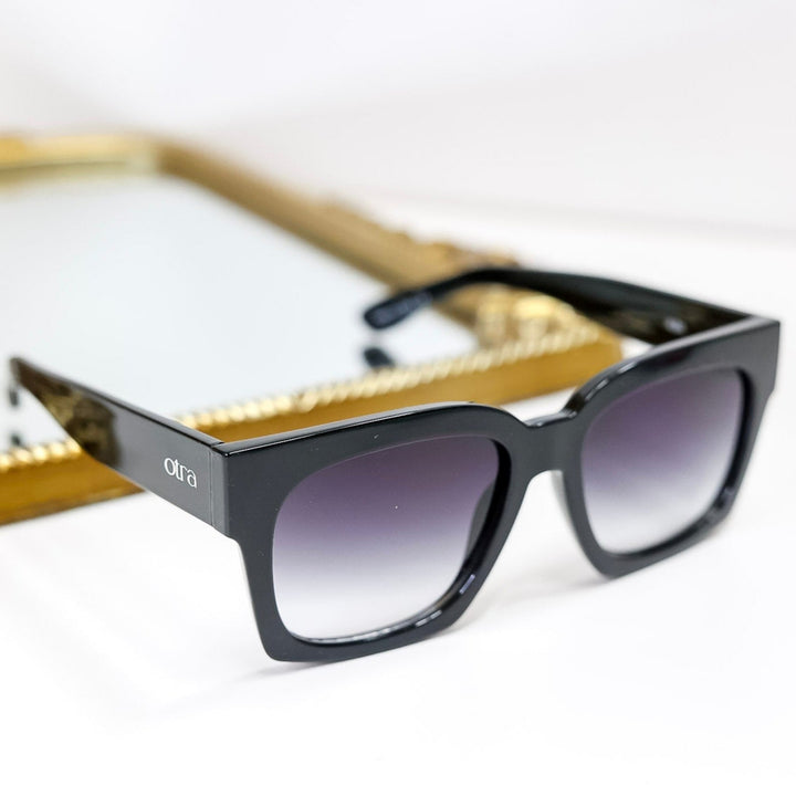 Black sunglasses with gradient lenses on a white background
