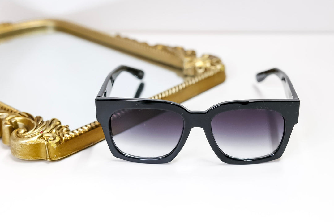 Black sunglasses with gradient lenses on a white background