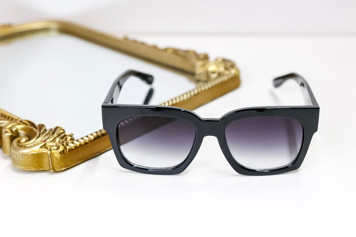 Black sunglasses with gradient lenses on a white background