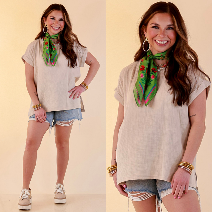 Model is wearing Short Sleeve Linen Top with Rolled Sleeve Detail in Beige with shorts against a beige backdrop. 