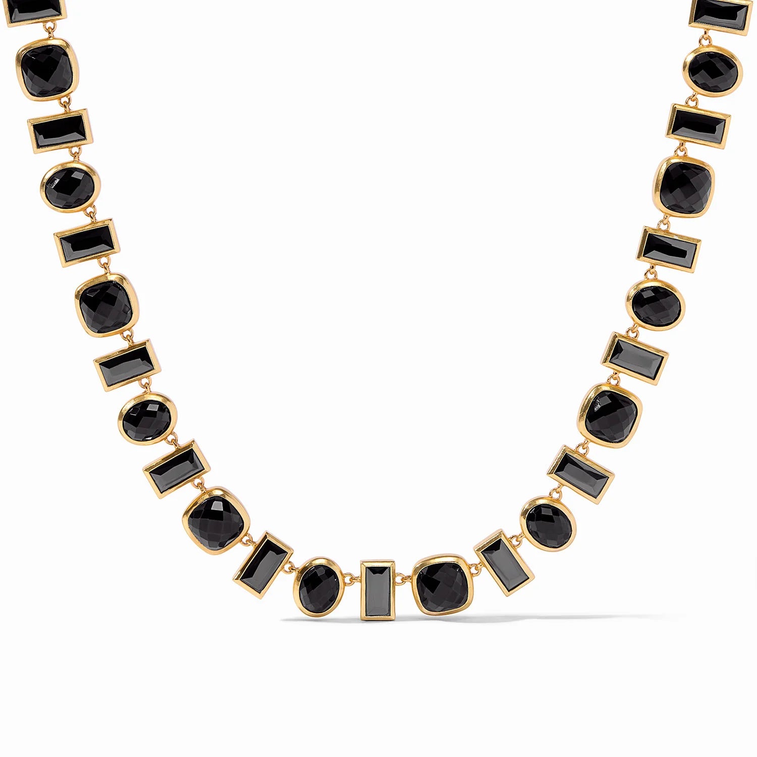 Gold necklace with black, rectangle crystals and square, iridescent clear crystals linked together. This necklace is pictured on a white background.
