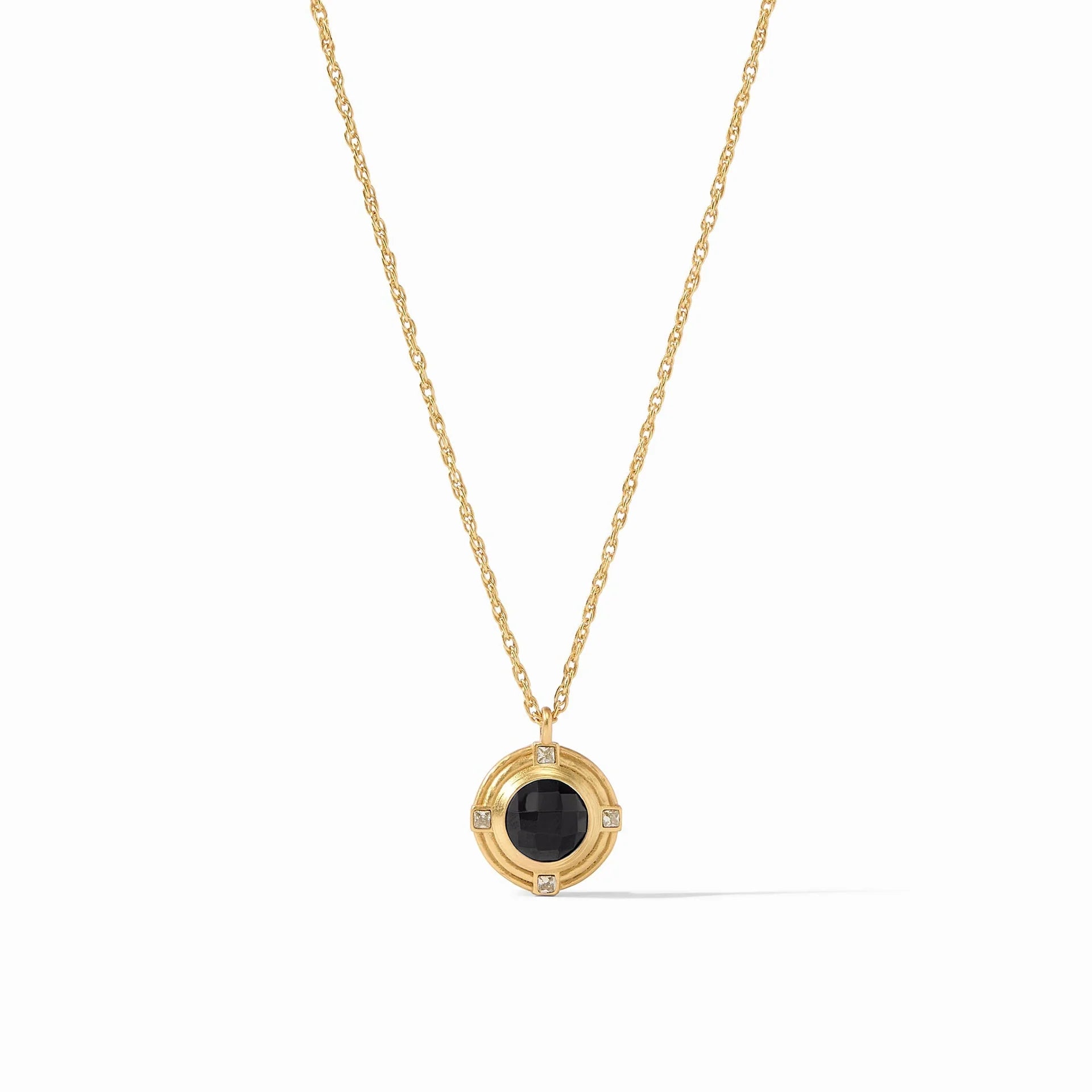Pictured is a gold chain necklace with gold and black pendant pictured on a white background.