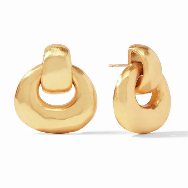 Pictured is a pair of gold doorknocker earrings on a white background. 