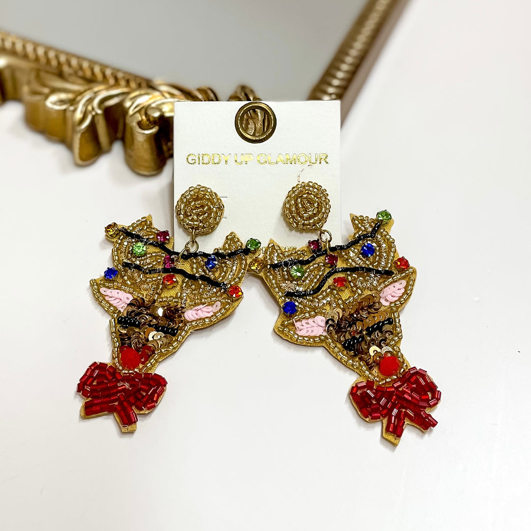 Beaded reindeer earrings with colorful lights, red nose, and pink bow. 3-inch festive Christmas statement jewelry.
