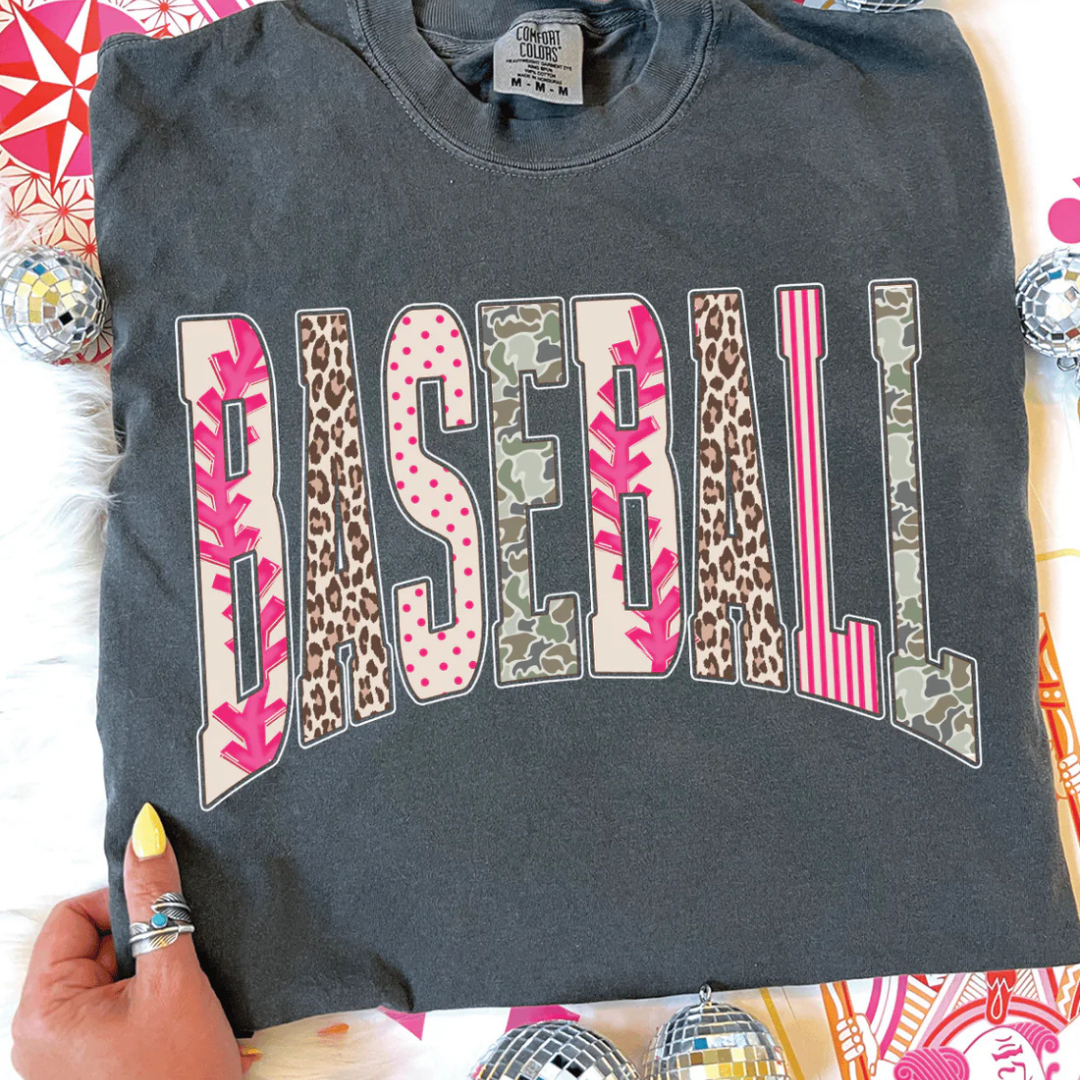 Comfort Colors graphic t-shirt featuring a bold BASEBALL design with mixed prints including baseball stitching, leopard, polka dots, stripes, and camo.