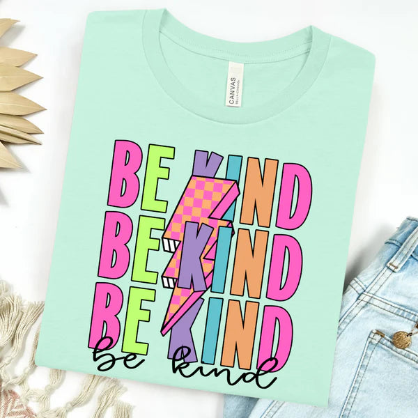 Mint green t-shirt with 'Be Kind' text in colorful letters on a white background.