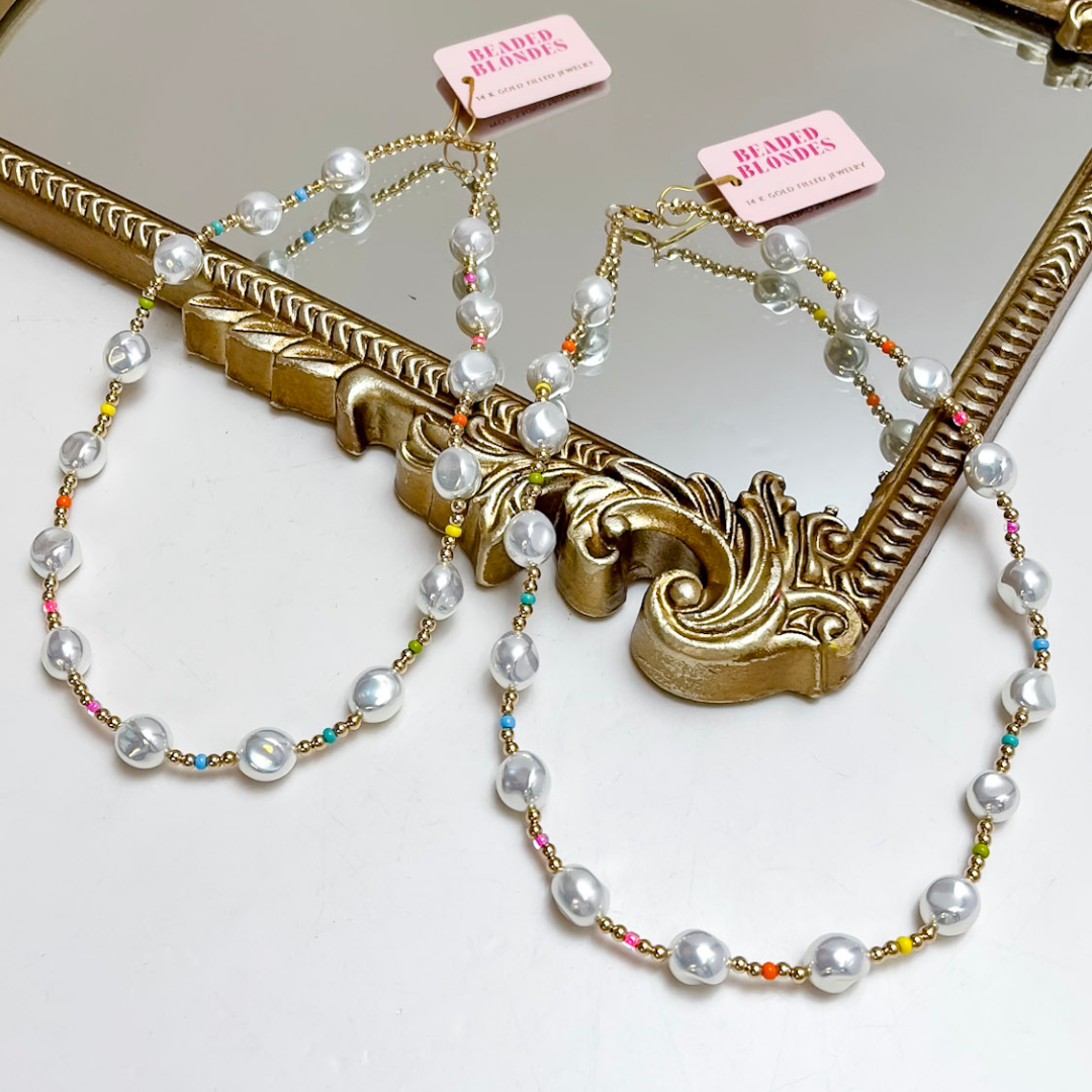 Pearl necklace with colorful beads on a decorative mirror