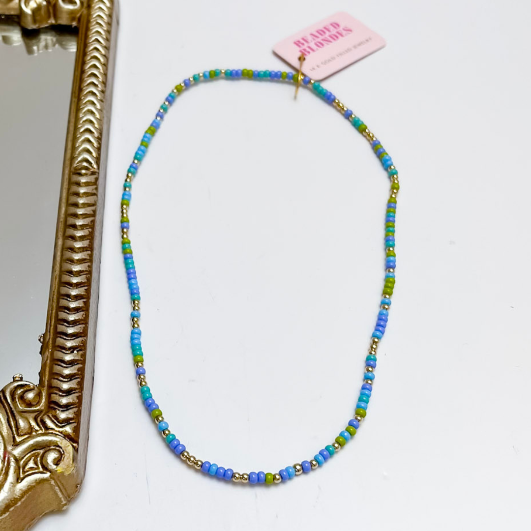 Beaded necklace with a pink tag on a white background