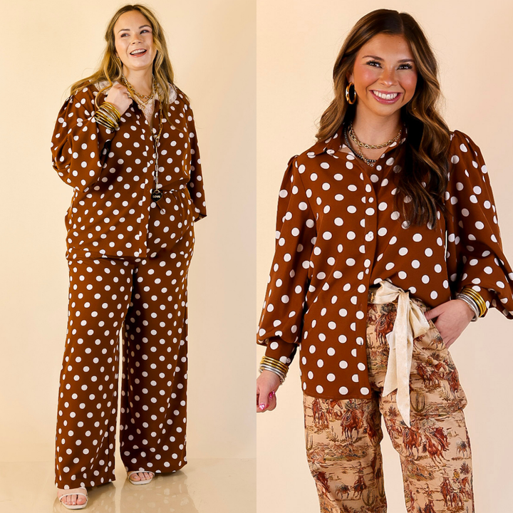 Models are wearing brown polka dot button up collared top on a beige background