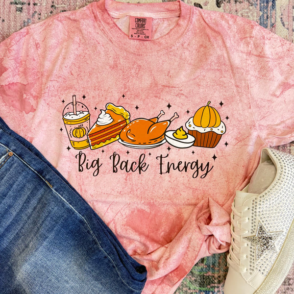 Pink t-shirt with Thanksgiving-themed graphics and 'Big Back Energy' text, displayed with jeans and a shoe.