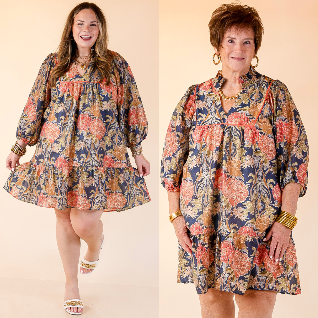 Two women wearing a navy mix floral dress on a beige background