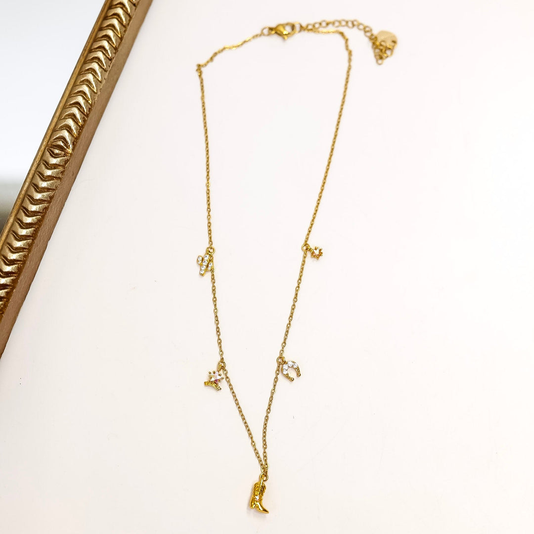 Gold necklace on a white surface with a decorative gold frame.