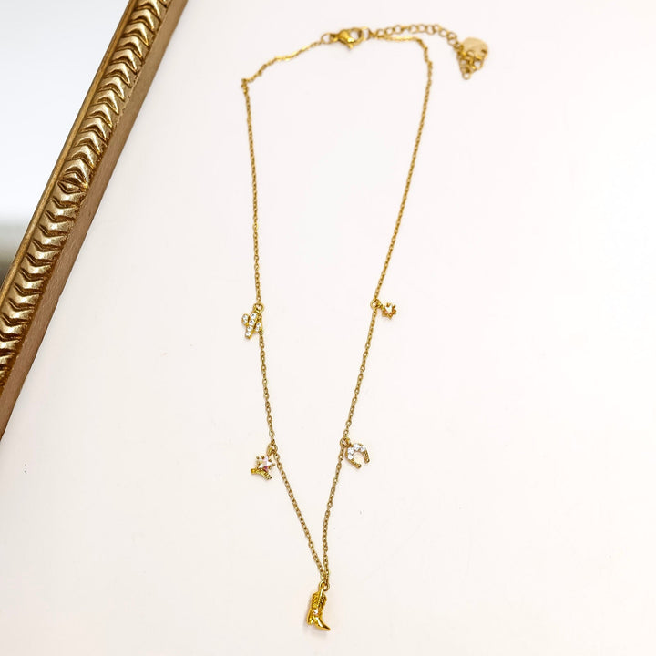 Gold necklace on a white surface with a decorative gold frame.