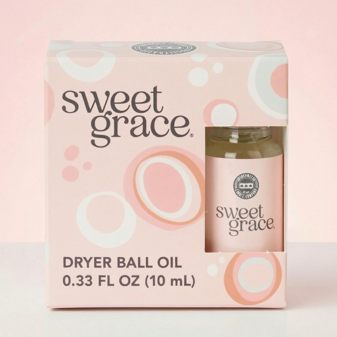Sweet Grace dryer ball oil packaging on a light pink background