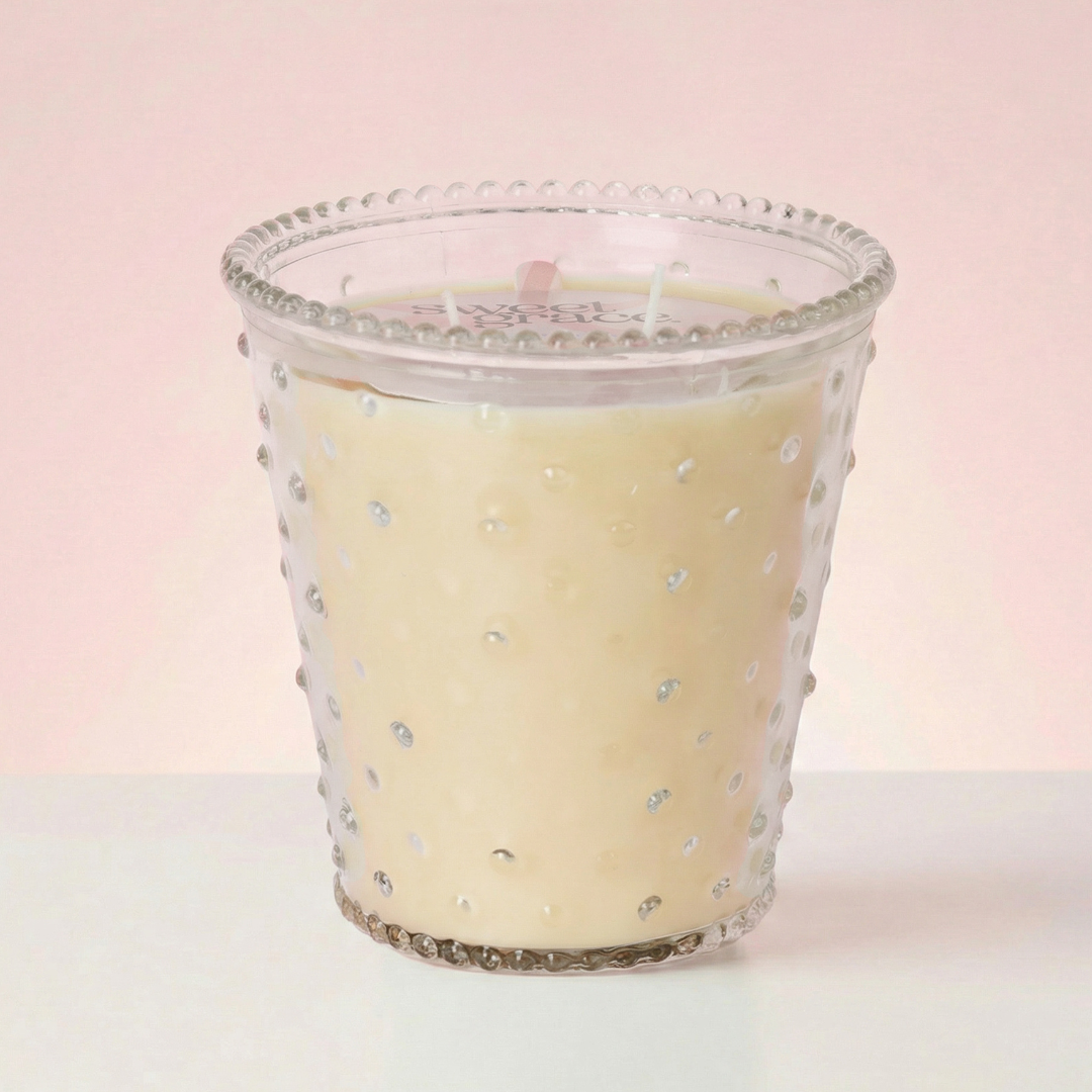 Glass Candle on pink background.