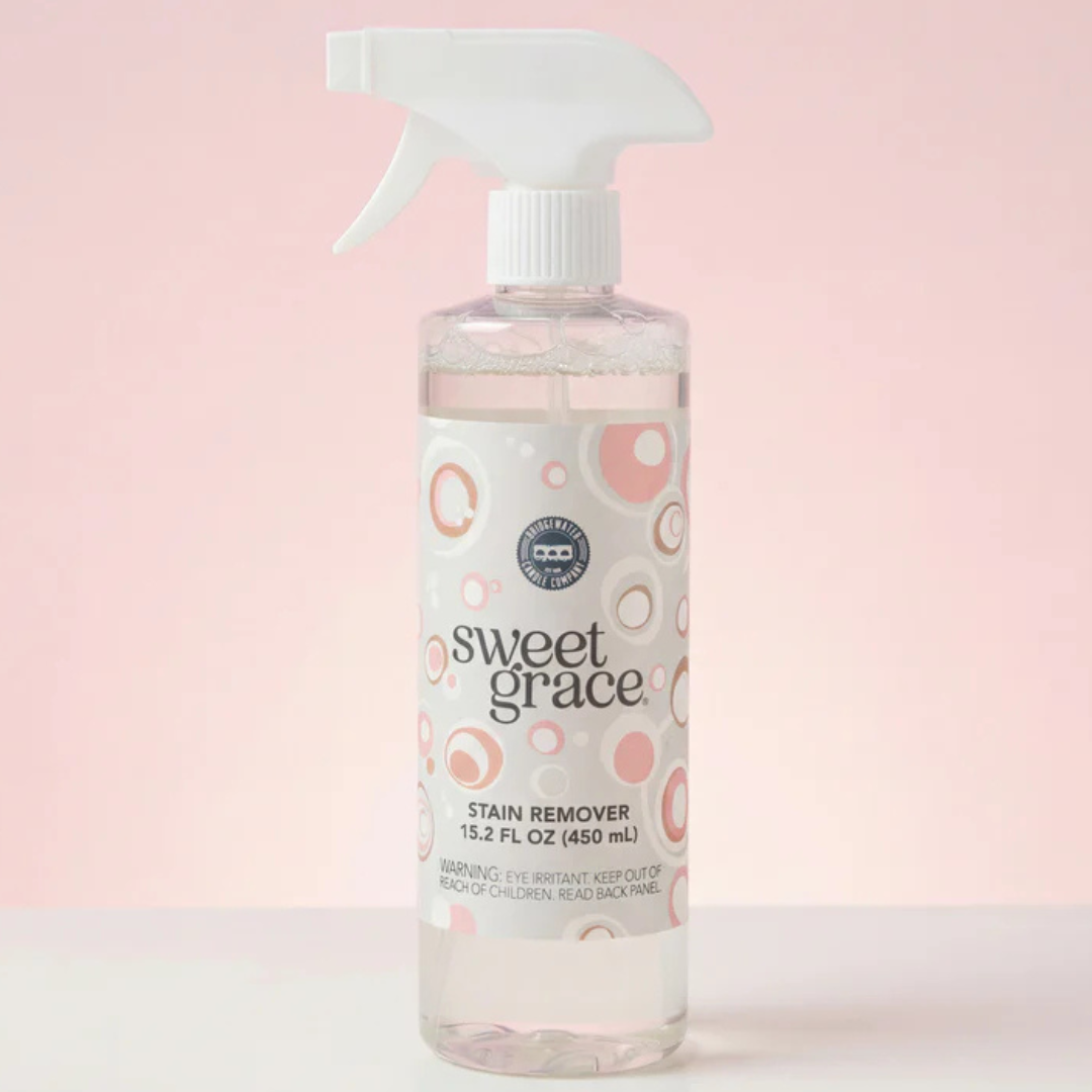 Bottle of sweet grace stain remover on a light pink background