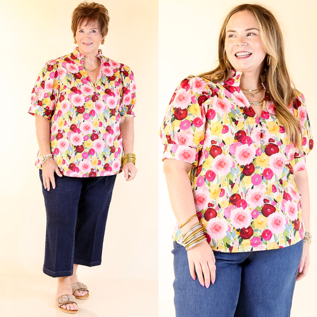 Two women wearing colorful floral shirts against a plain background