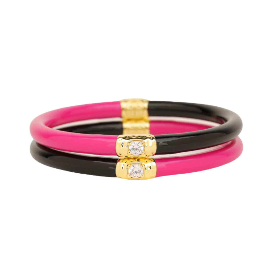 Set of three colorful bangles with gold accents on a white background