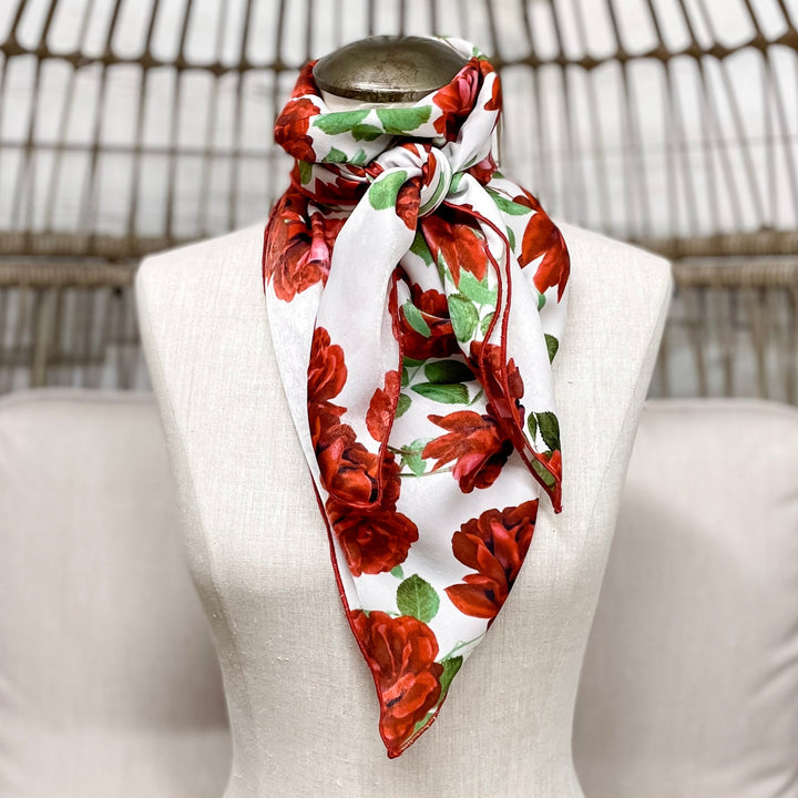 Mannequin wearing a floral scarf with a wicker chair background