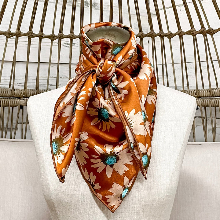 Mannequin head with a patterned scarf on a wicker chair
