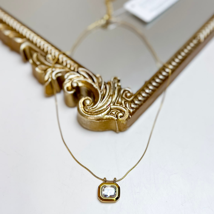 CHANSUTT PEARLS Daisy Crystal Pendant Necklace in Gold featuring a delicate gold-tone chain and square clear faceted crystal pendant in a polished gold frame.