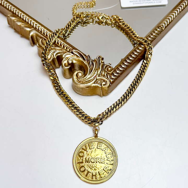 CHANSUTT PEARLS Meredith Large Pendant Necklace featuring a chunky gold-tone chain and round medallion pendant with a Love Each Other More message.