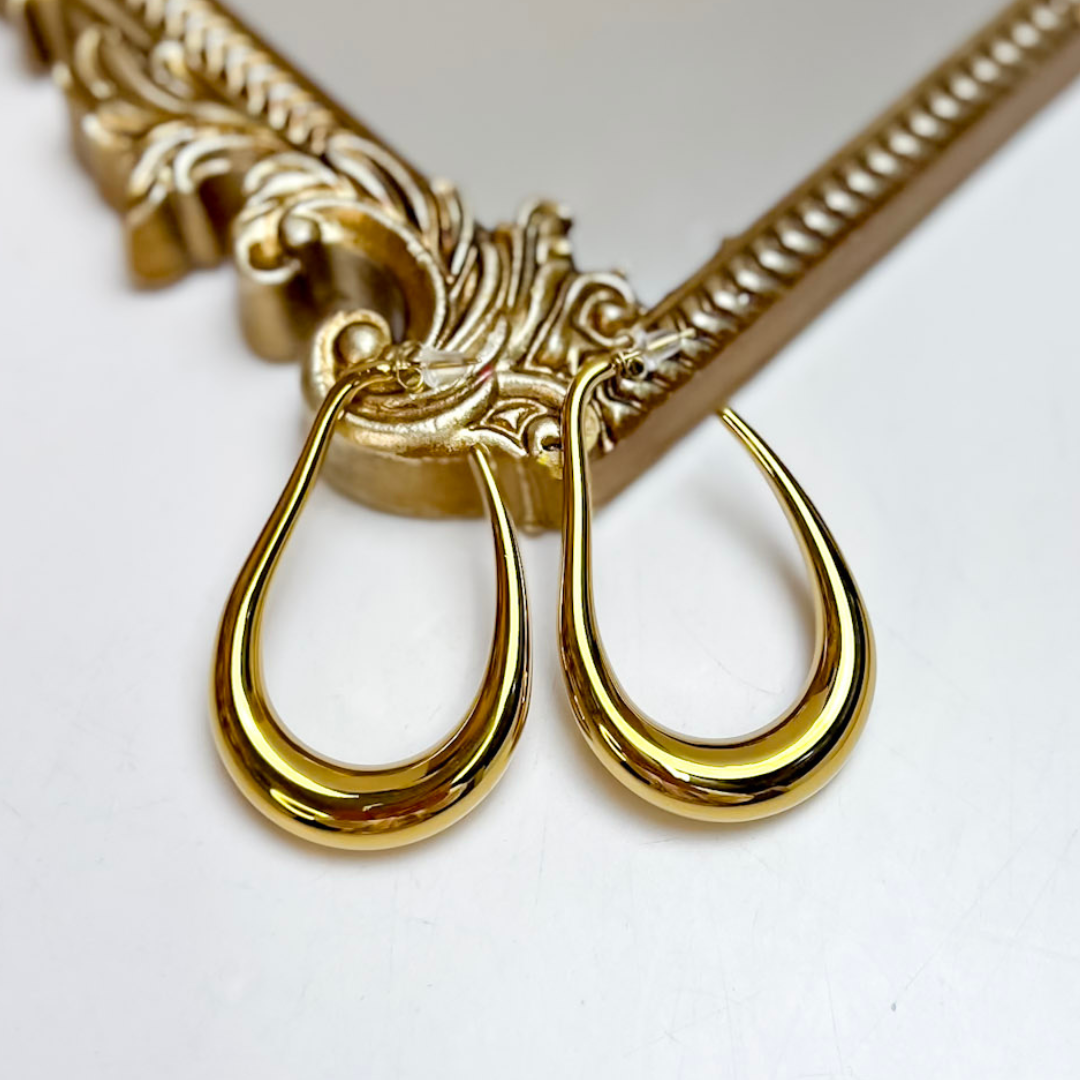 ChanSutt Pearls Sophie Large Hoop Earrings in Gold featuring oversized polished gold-tone teardrop hoops with a lightweight open design.