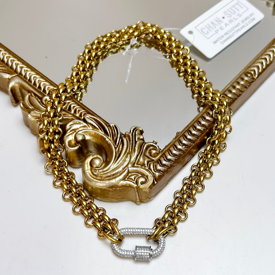 CHANSUTT PEARLS Kristi Chain Necklace featuring layered gold-tone chains and a sparkling silver crystal-accented carabiner pendant clasp.