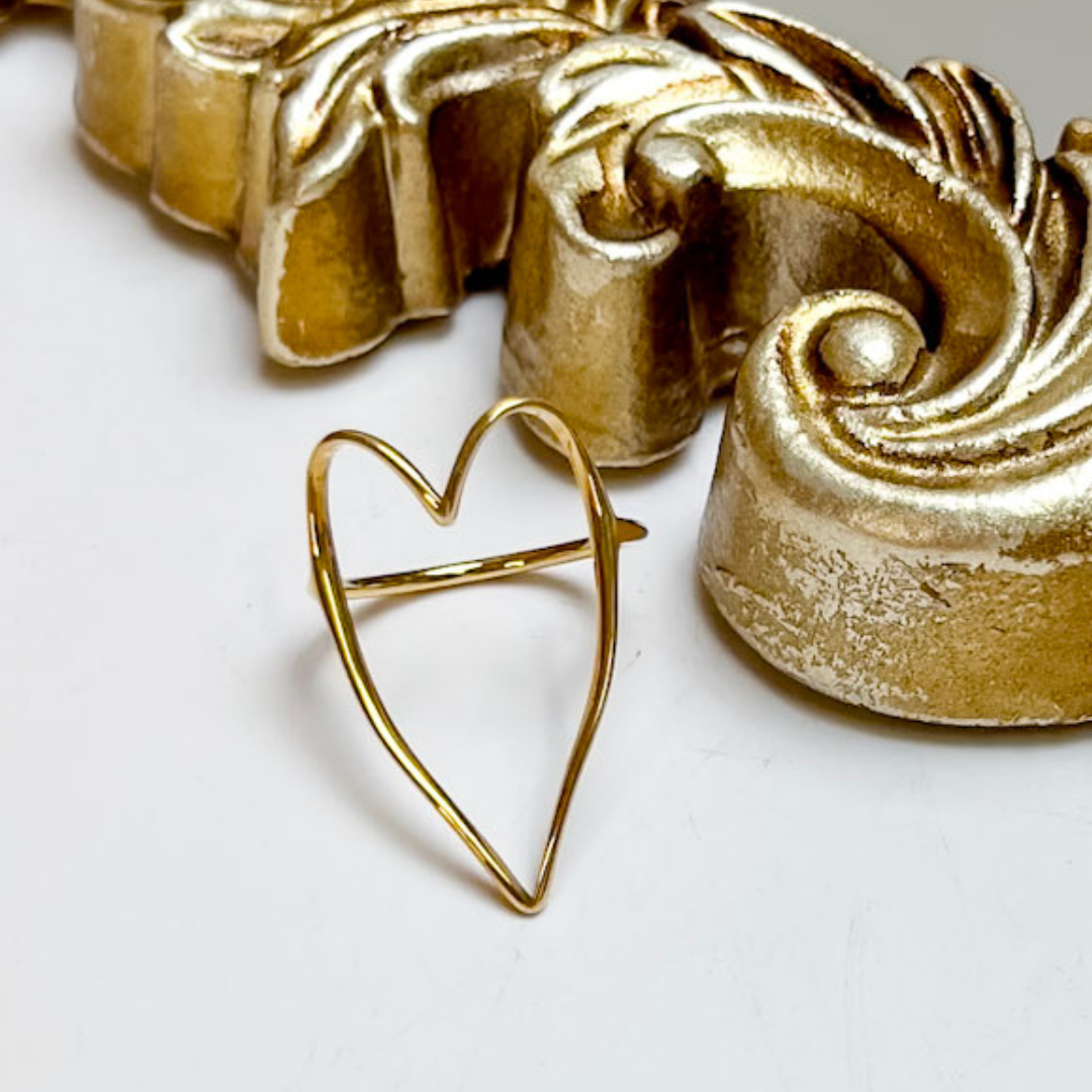 CHANSUTT PEARLS The Large Heart Ring in Gold featuring an oversized open-heart silhouette with a sleek, polished gold-tone wire design.
