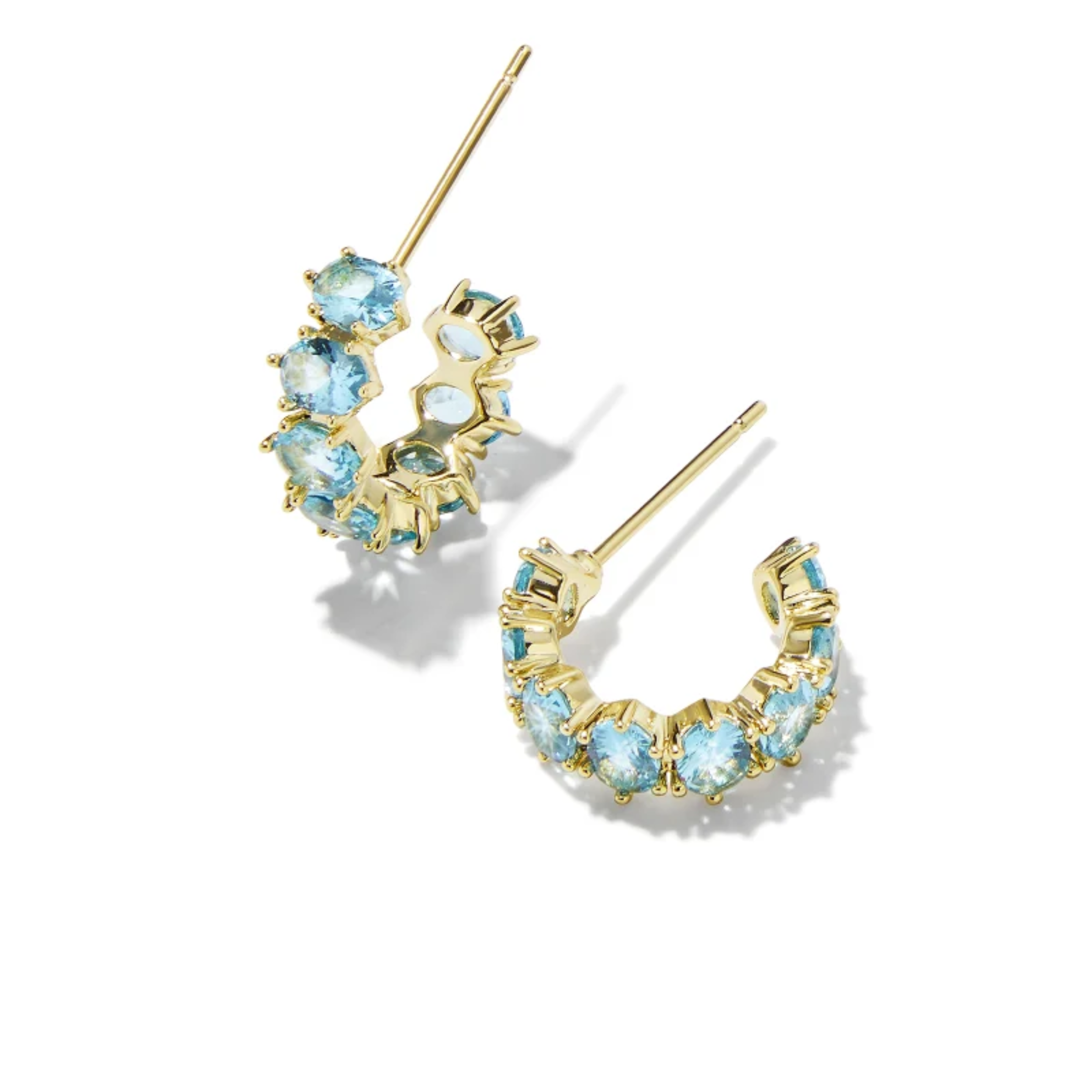These Cailin Crystal Huggie Earrings in Aqua Crystal by Kendra Scott are pictured on a white background.