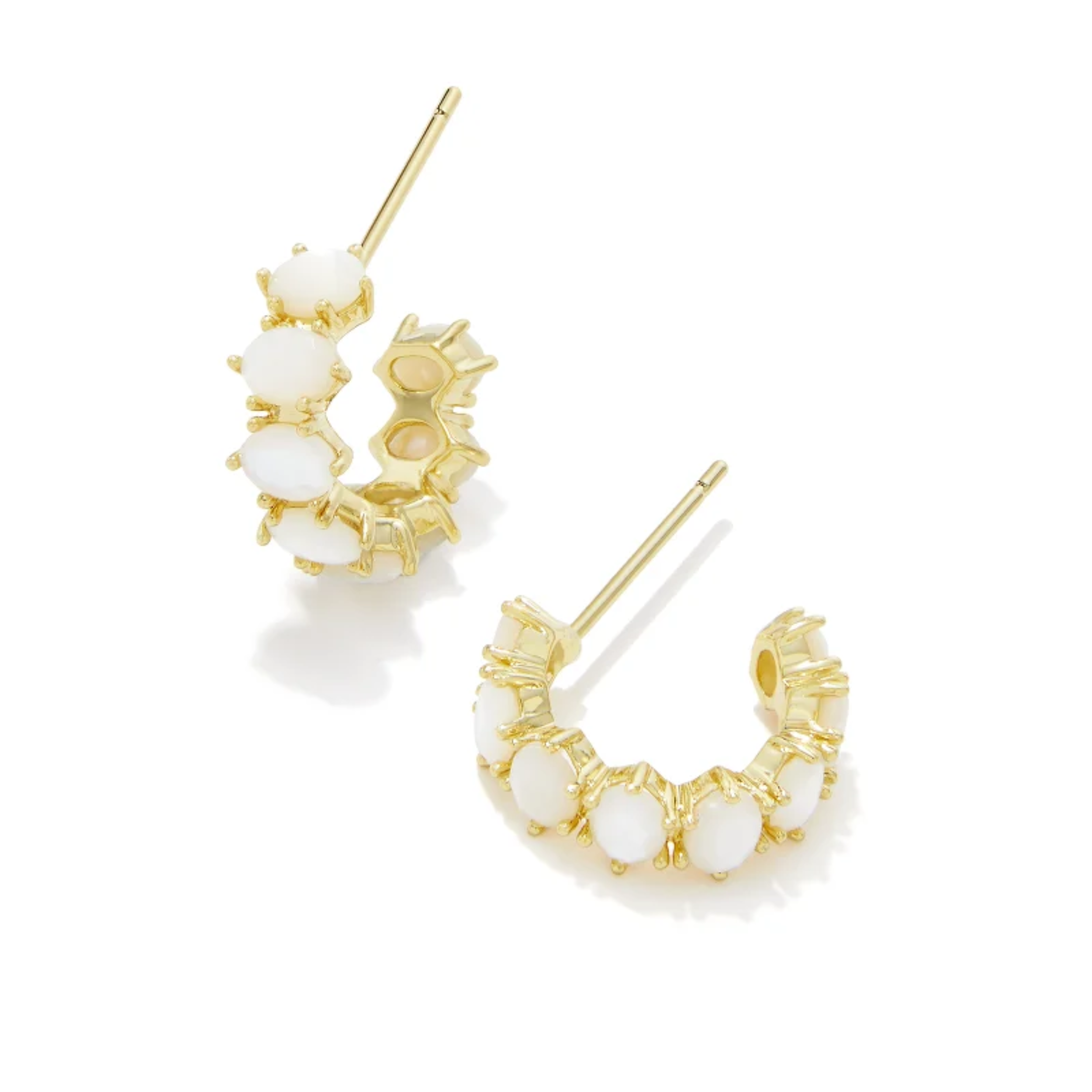 These Cailin Gold Crystal Huggie Earrings in Ivory Mother-Of-Pearl by Kendra Scott are pictured on a white background.
