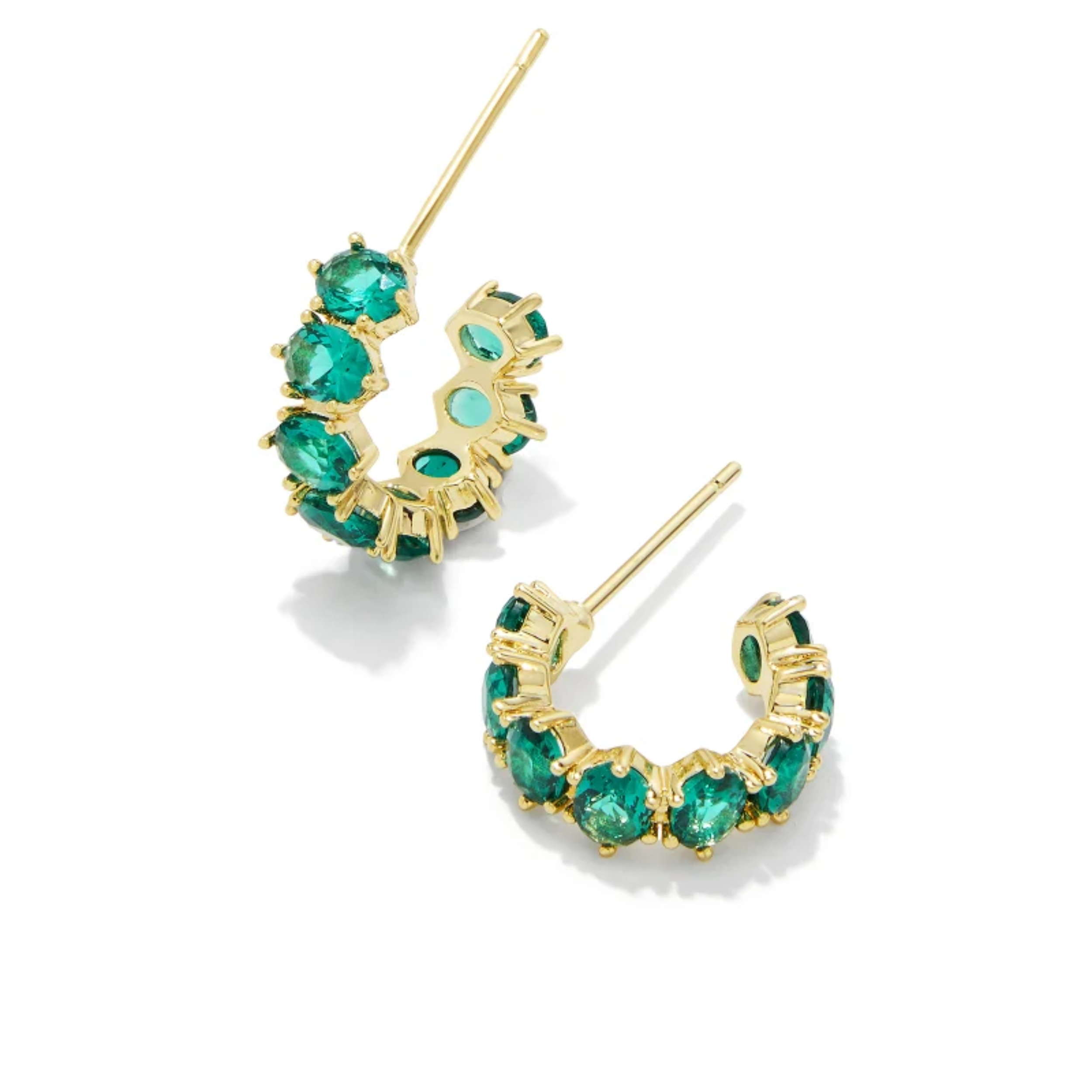 These Cailin Gold Crystal Huggie Earrings in Green Crystal by Kendra Scott are pictured on a white background.
