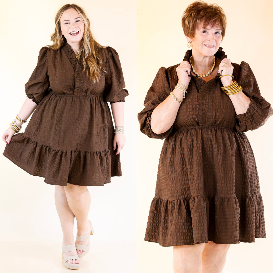 Two women wearing chocolate brown dresses on a plain background