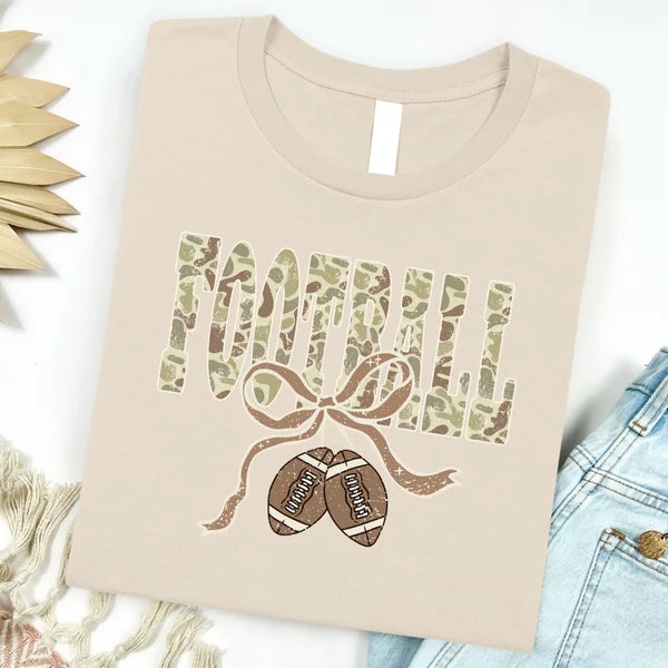Beige t-shirt with football and ribbon design on a white background
