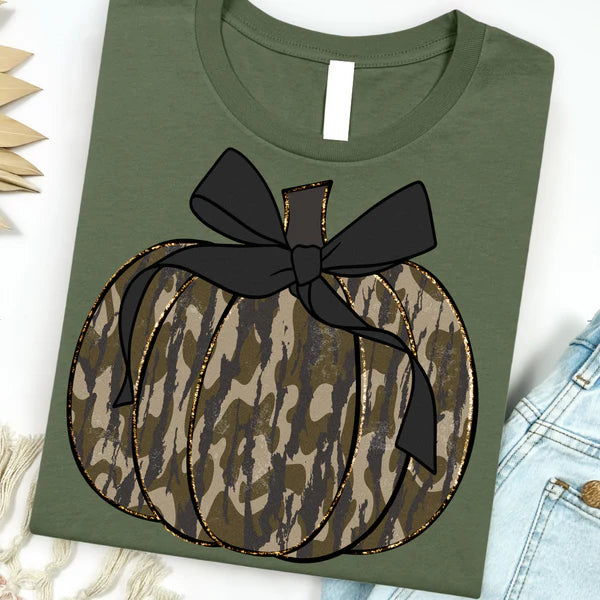 Green t-shirt with a camo pumpkin and black bow design on a white background.
