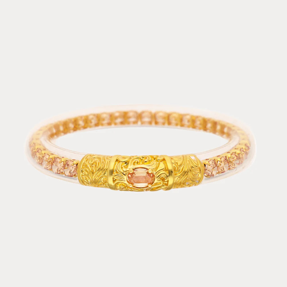 BuDhaGirl Champagne Sovereign All Weather Bangle with champagne crystals and ornate gold-tone centerpiece.