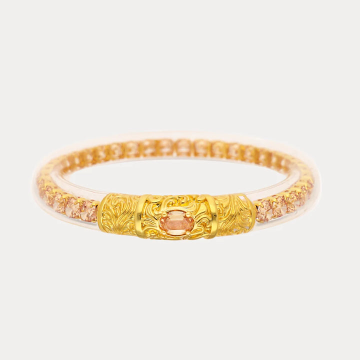 BuDhaGirl Champagne Sovereign All Weather Bangle with champagne crystals and ornate gold-tone centerpiece.
