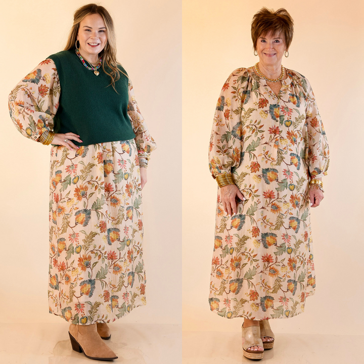 Models are wearing floral print maxi dress with long sleeves in cream against a plain background.