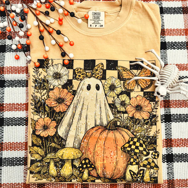 T-shirt with a ghost, pumpkin, and floral design on a plaid background