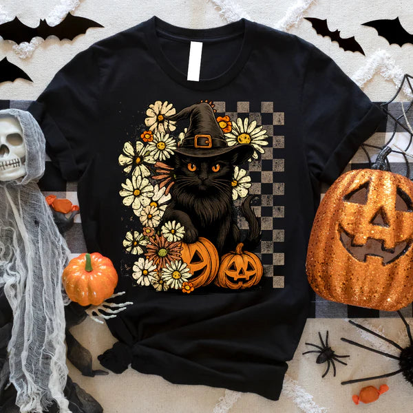 Black t-shirt with a Halloween-themed design featuring a black cat, pumpkins, and flowers on a checkered background.
