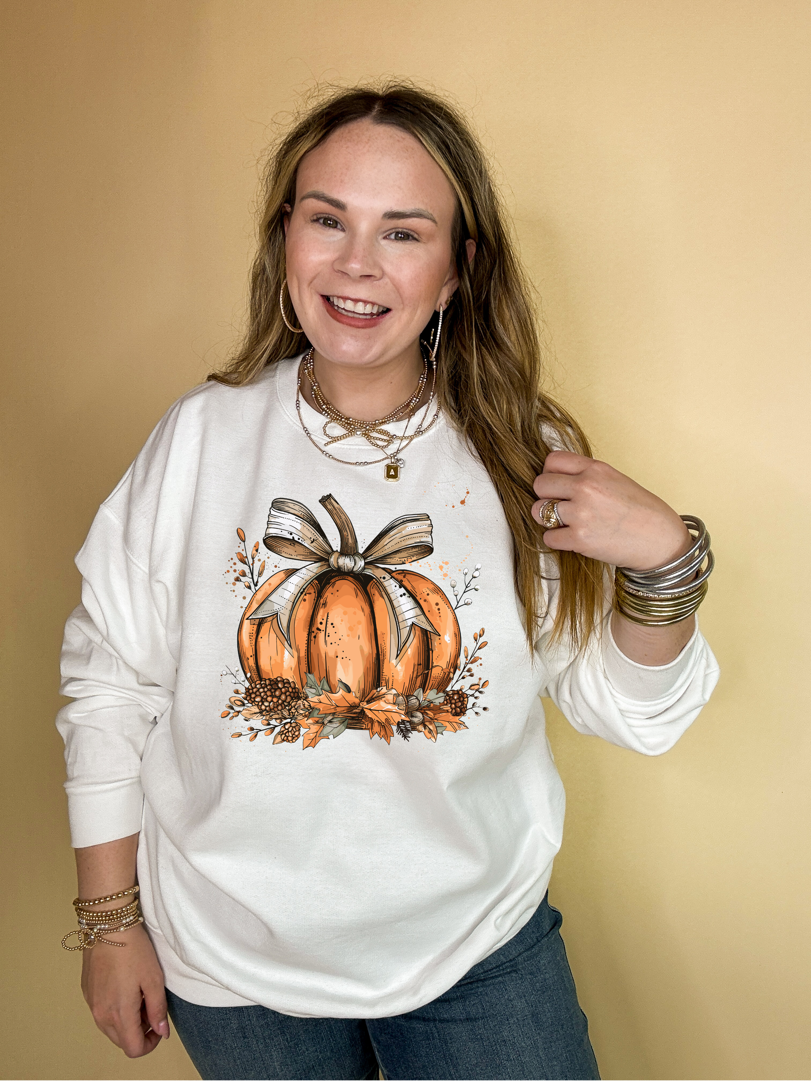 Online Exclusive | Chic Autumn Pumpkin on a Bed of Leaves with Off White Bow Graphic Sweatshirt in Multiple Color Options