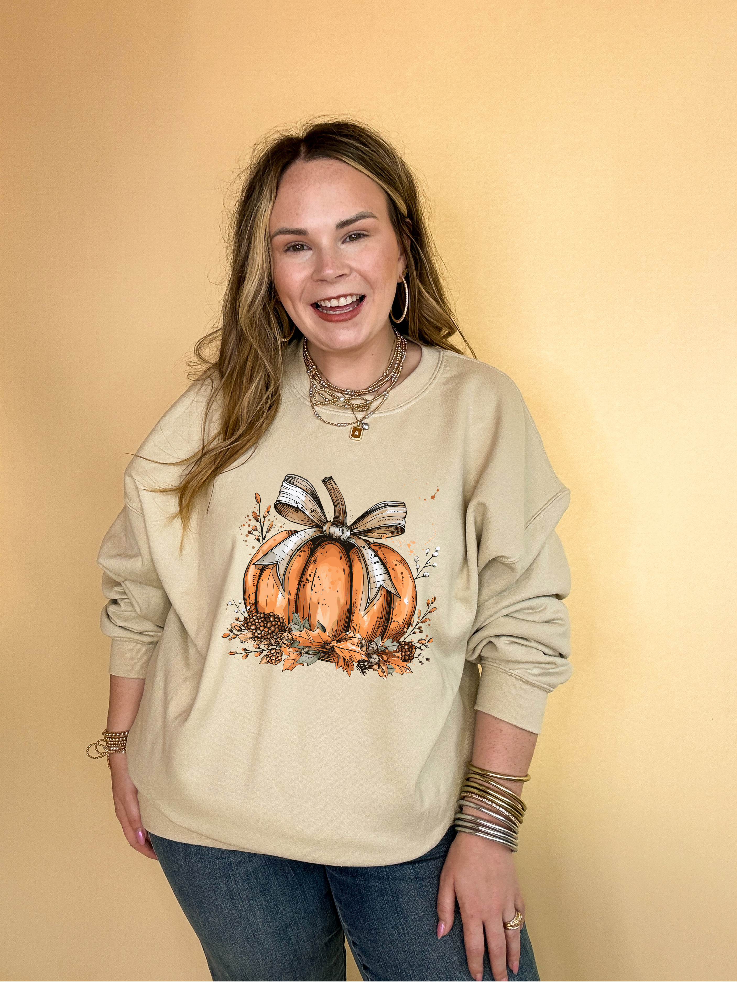 Online Exclusive | Chic Autumn Pumpkin on a Bed of Leaves with Off White Bow Graphic Sweatshirt in Multiple Color Options