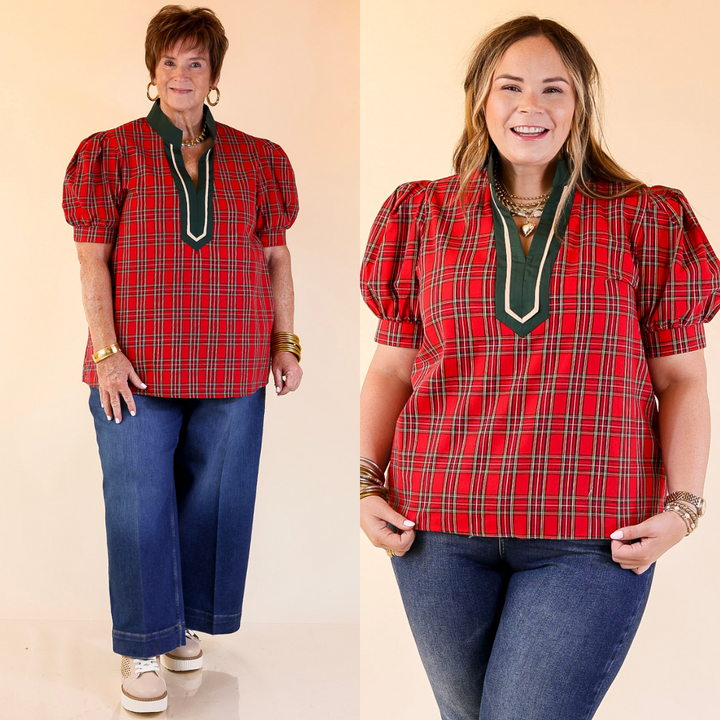 Two women wearing red plaid tops with green accents and blue jeans on a beige background
