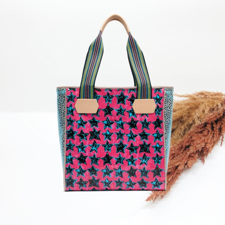 Tote bag with star pattern and striped handles on a white background