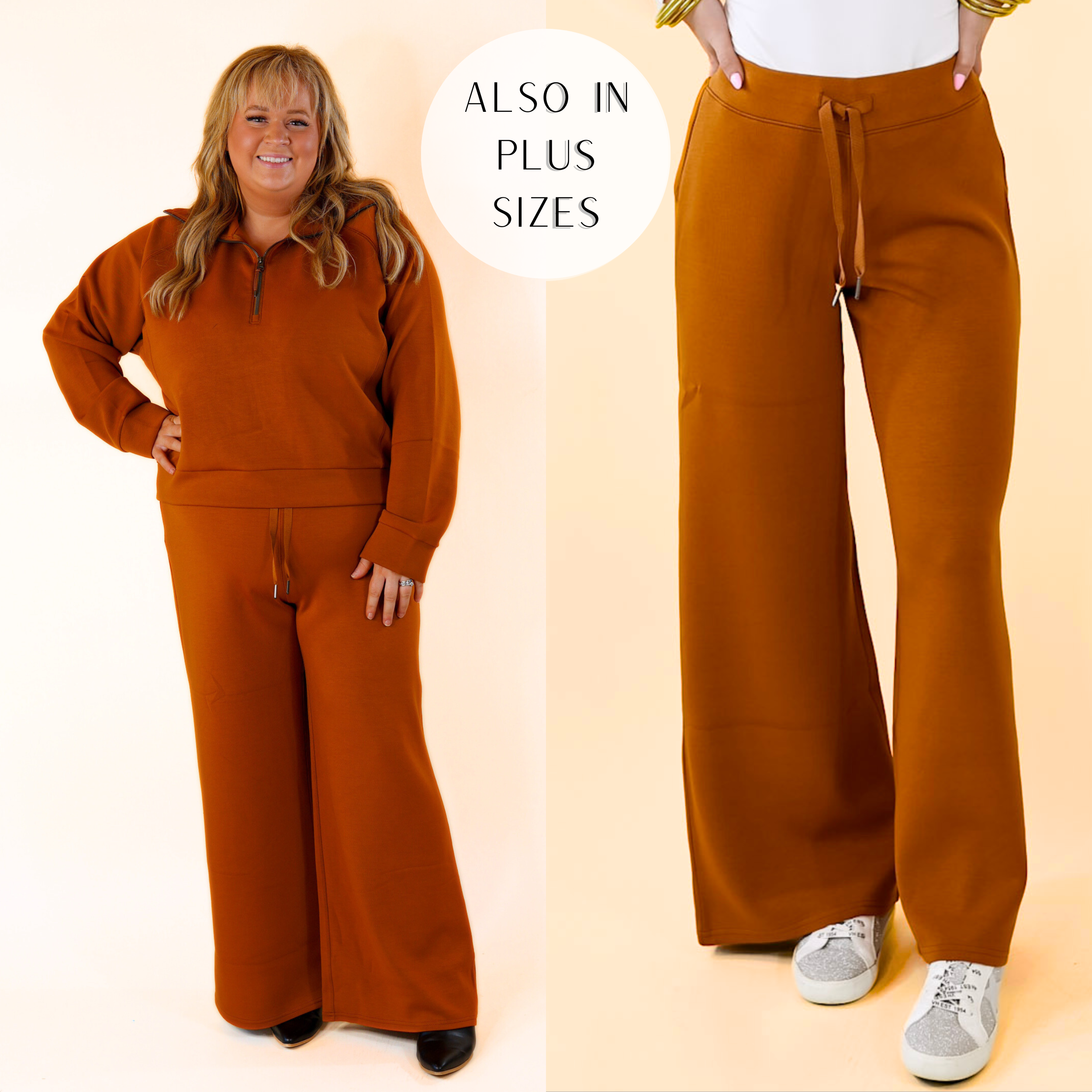Model is wearing a pair of wide leg sweatpants in rust brown. Model has these pants paired with a white bodysuit, silver sneakers. and gold jewelry.