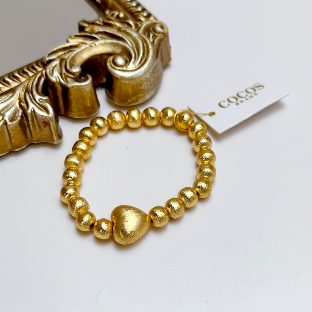 Gold bracelet on white background.