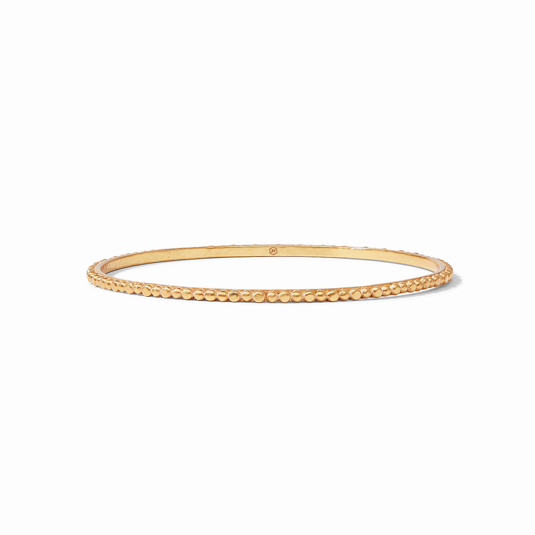 Gold beaded bangle on a white background