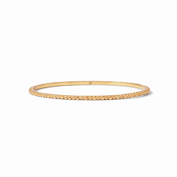 Gold beaded bangle on a white background